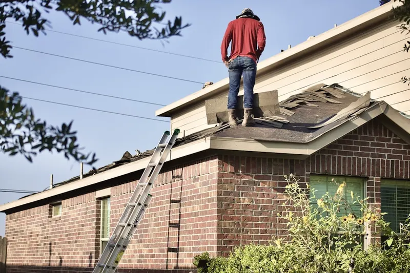 Professional roofer working on a residential roof in Oak Forest - Garden Oaks
